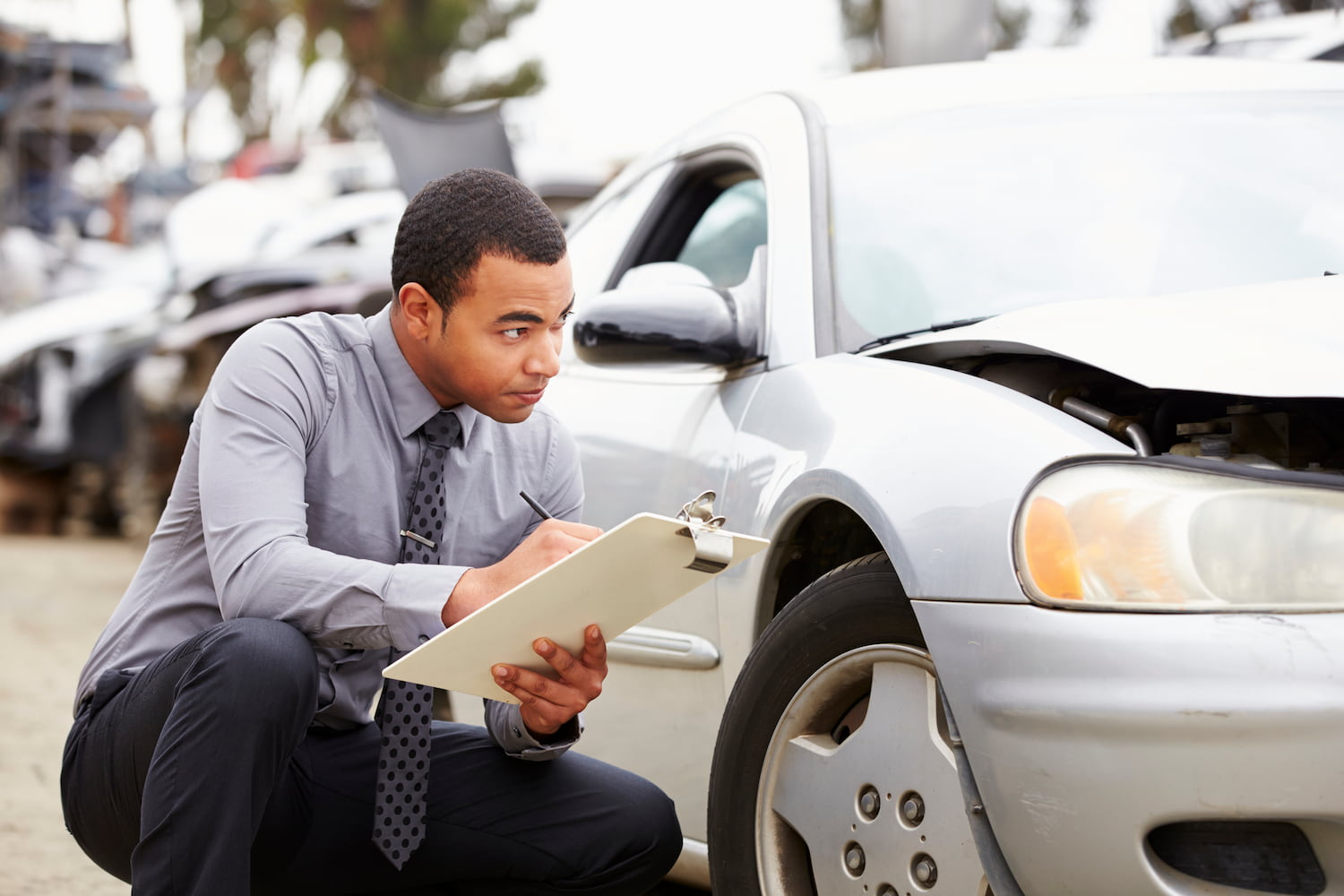 Person inspecting car involved In an accident.