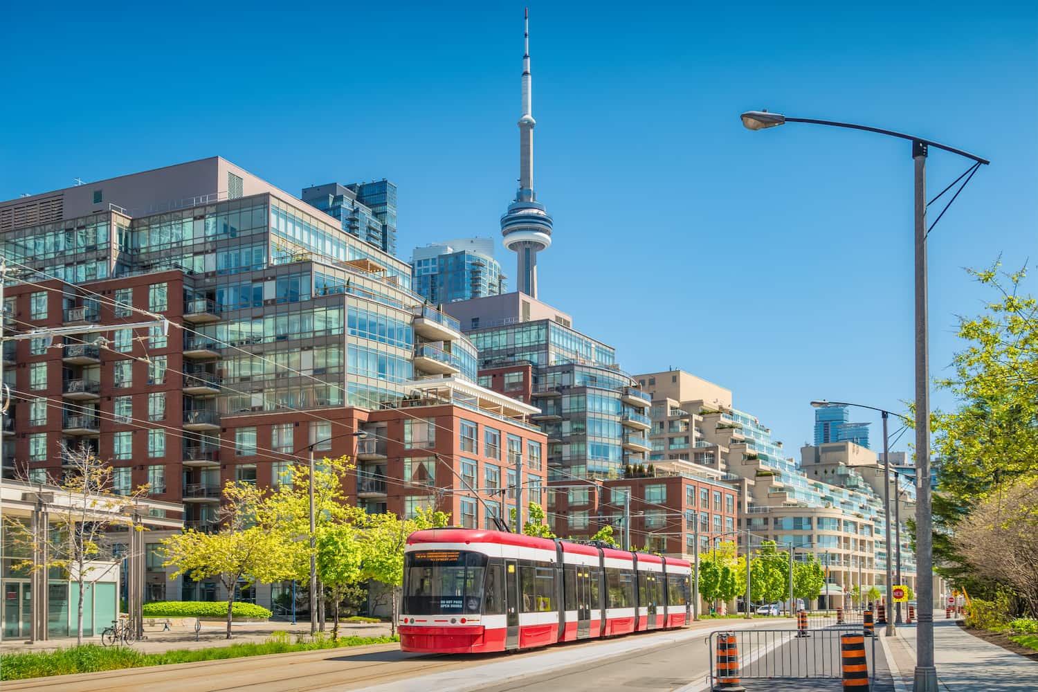 Street car and new condominium buildings in downtown Toronto on a sunny day