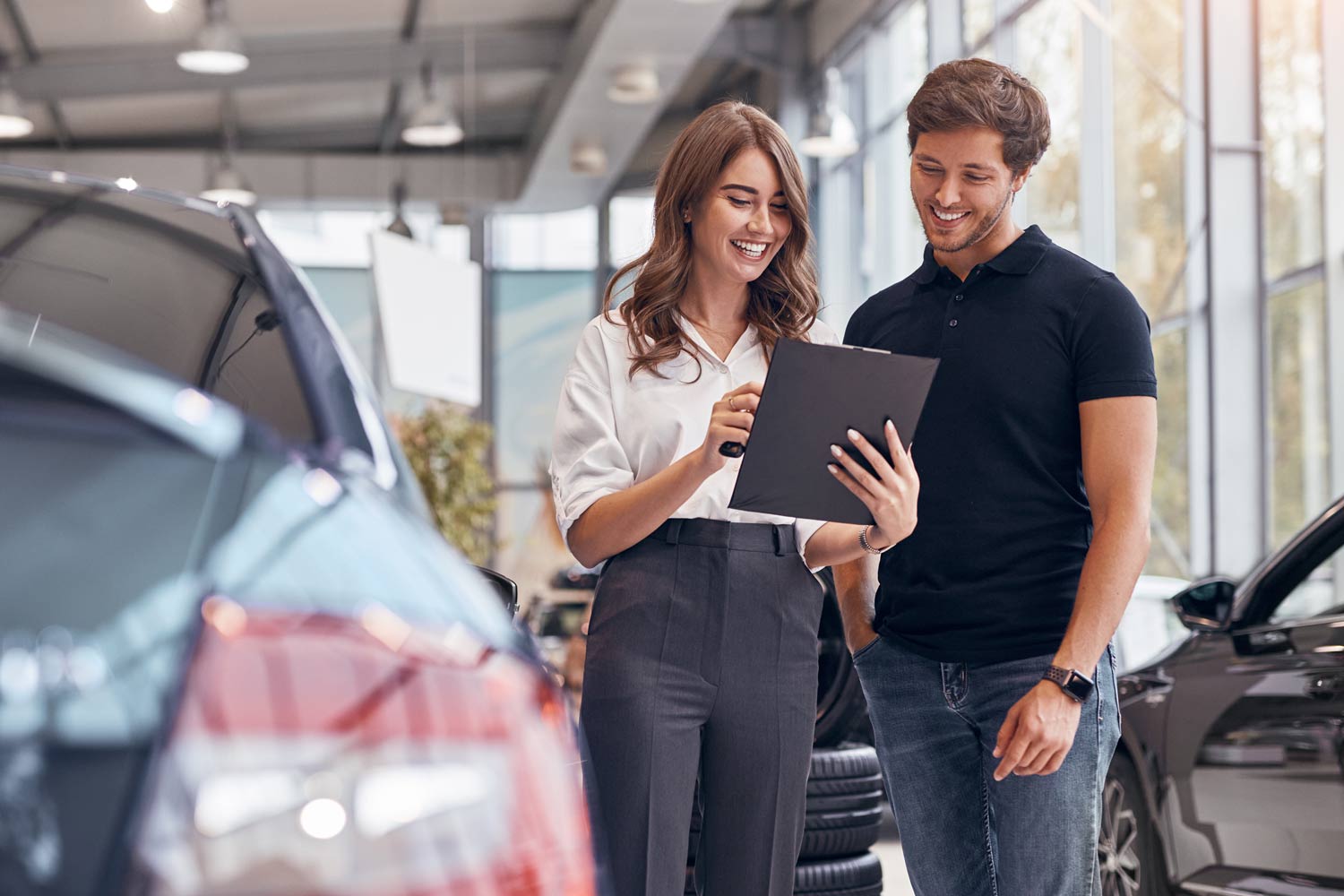 Car dealer discussing contract with a client.