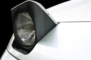 Closeup of a white car pop up headlight