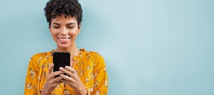 Woman looking at digital pink slip in mobile phone