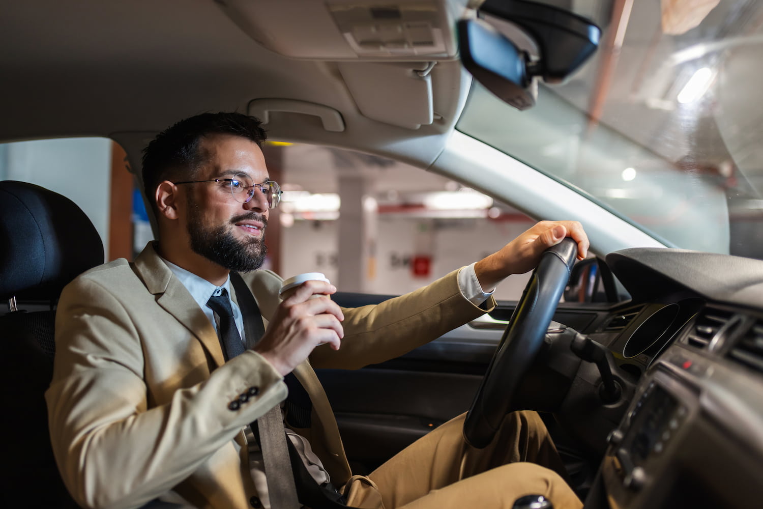 Young professional looking for a parking spot in an underground garage.