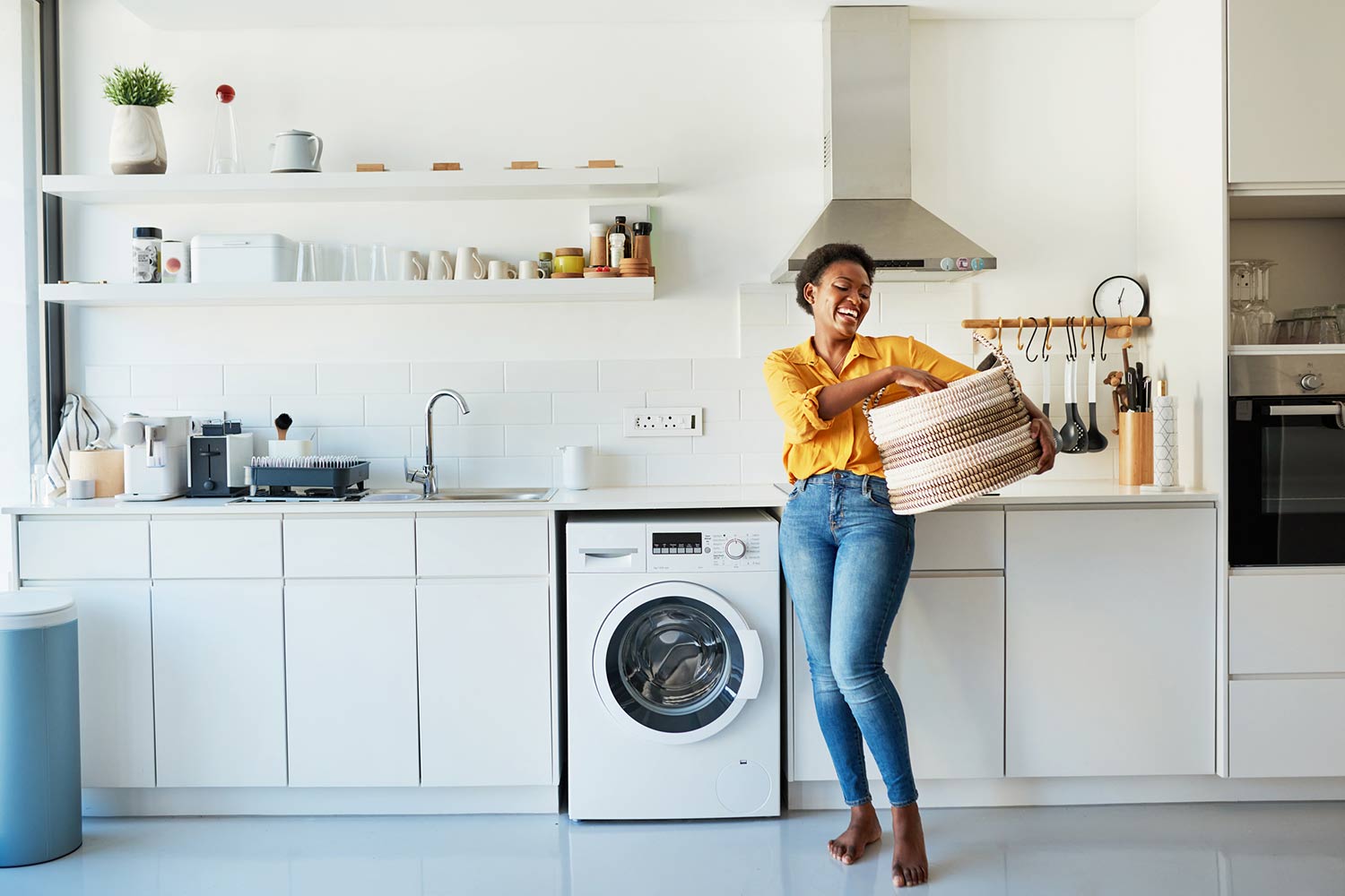 Shot of a young woman doing her laundry at home.