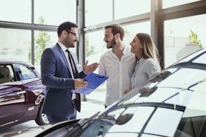 A couple talking to a car agent