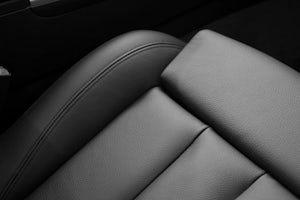 A closeup of a new car leather seat