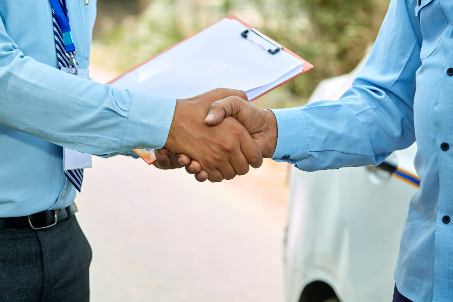 A close-up of two men handshaking