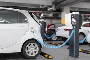 Close-up View Of Charging Electric Car In Parking Garage