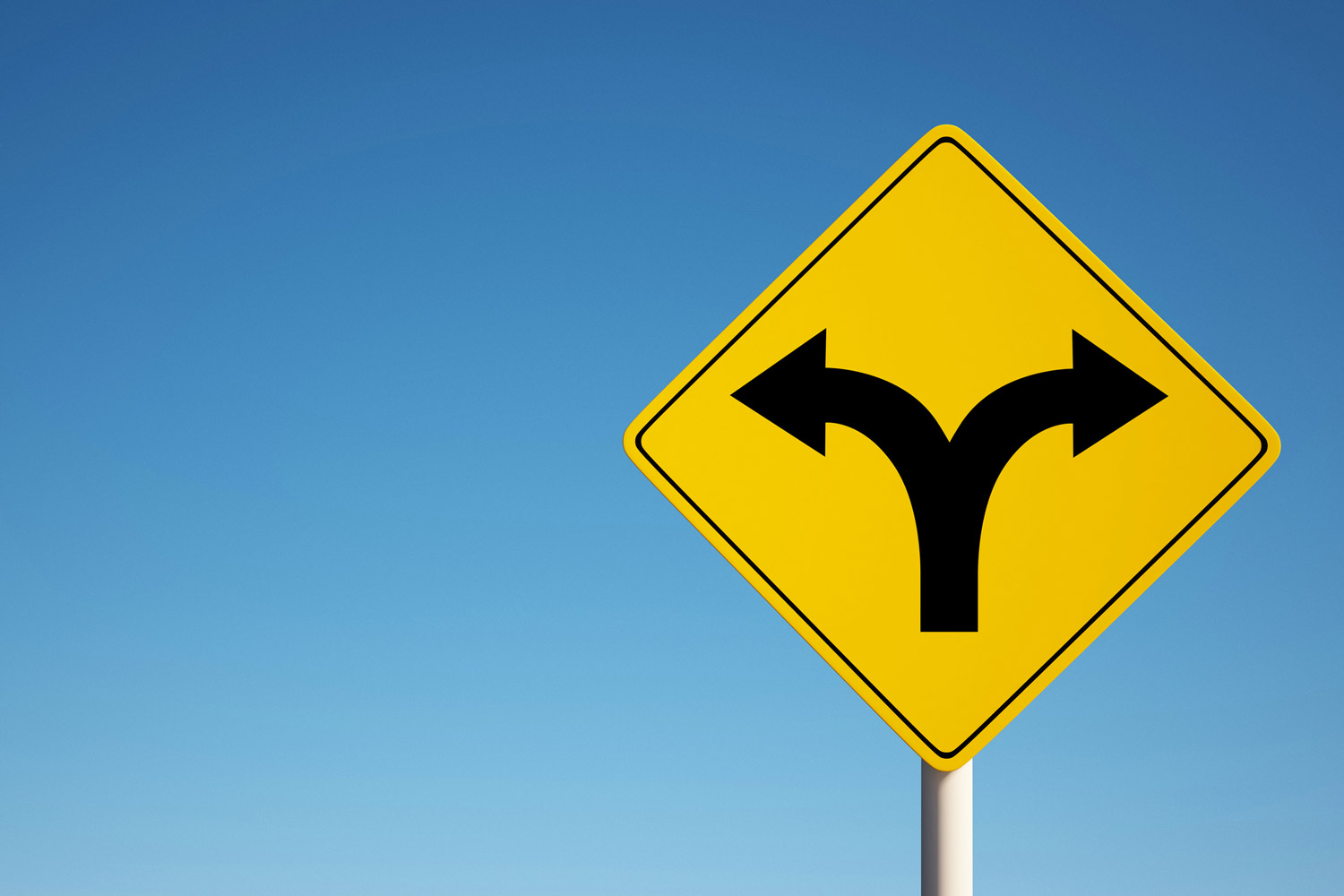 Dividing Sign isolated on clean blue sky