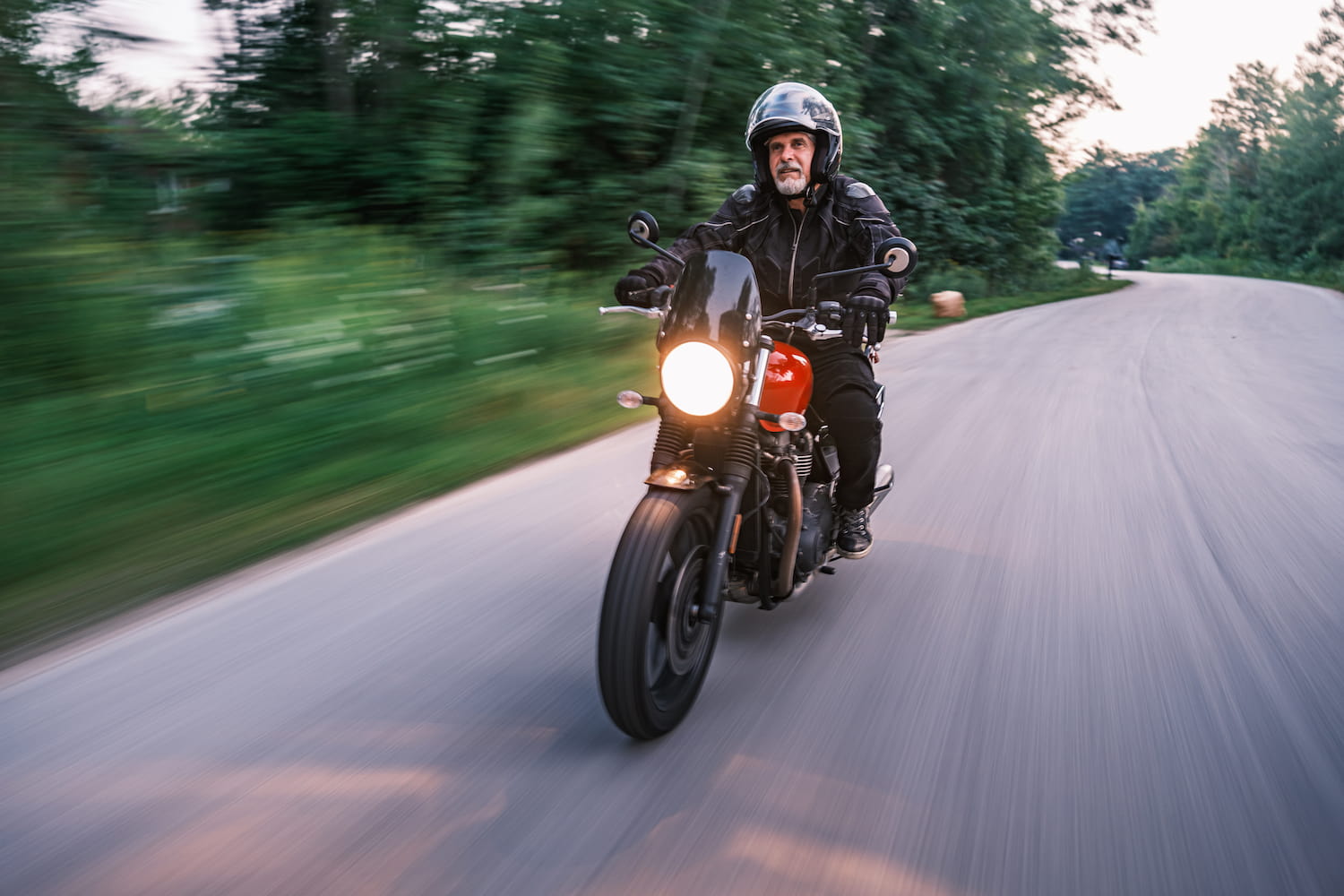 Person riding his motorbike in the countryside at dawn