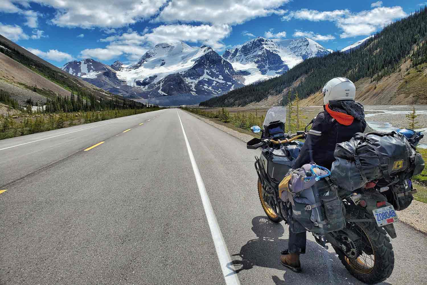 A person sits on a motorcycle facing a mountain to the south.