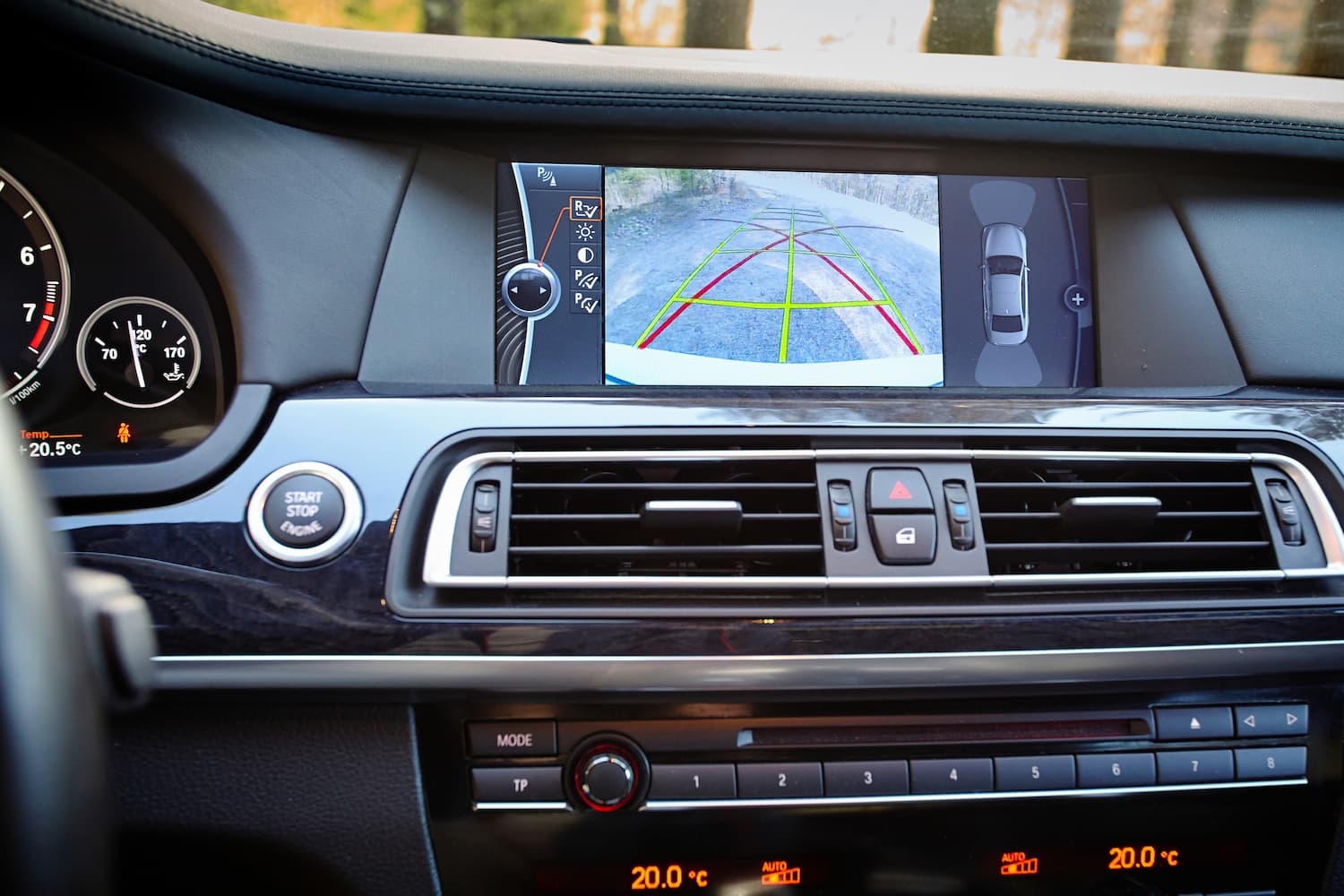 car interior featuring a rearview camera with dynamic trajectory lines and parking assistance.