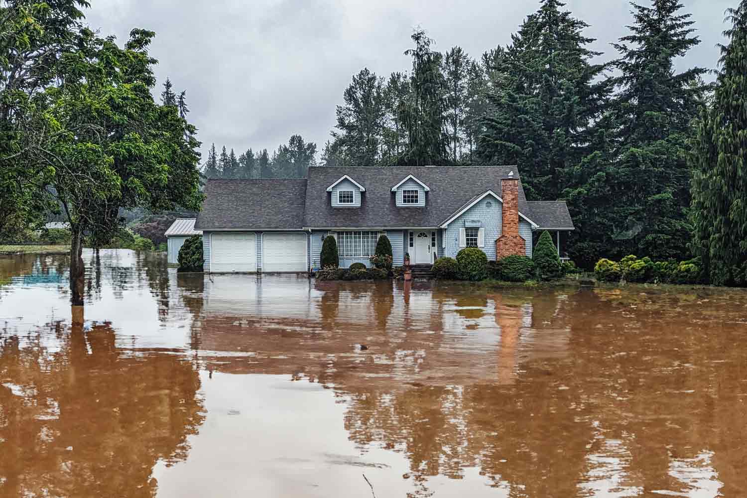 House exterior with flooded yard.
