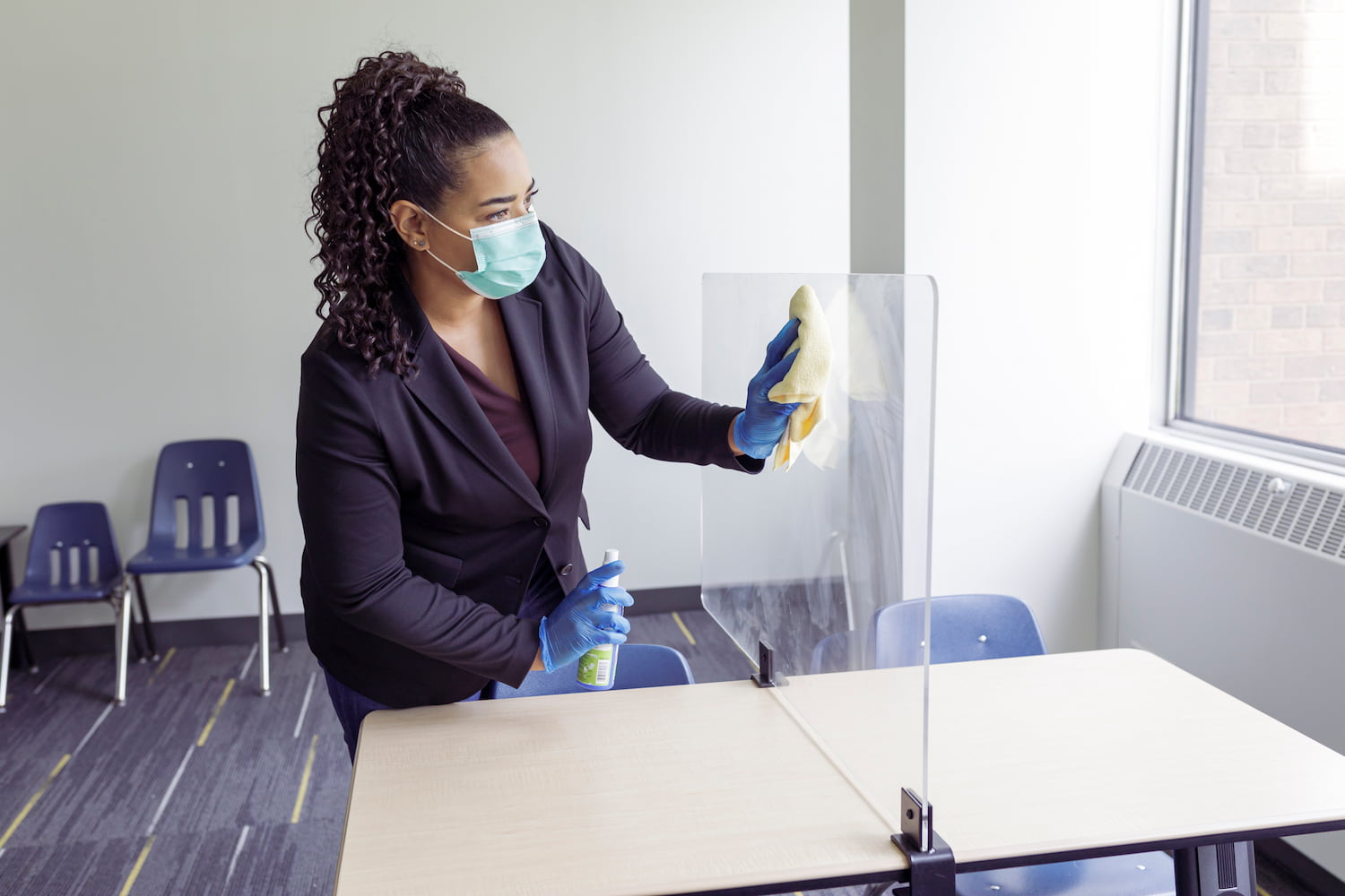 Person cleaning a classroom.