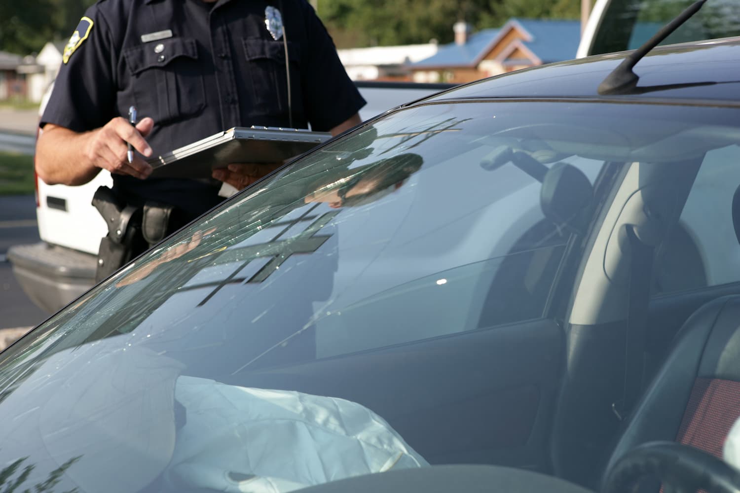 A policeman talks to a driver during traffic stop.