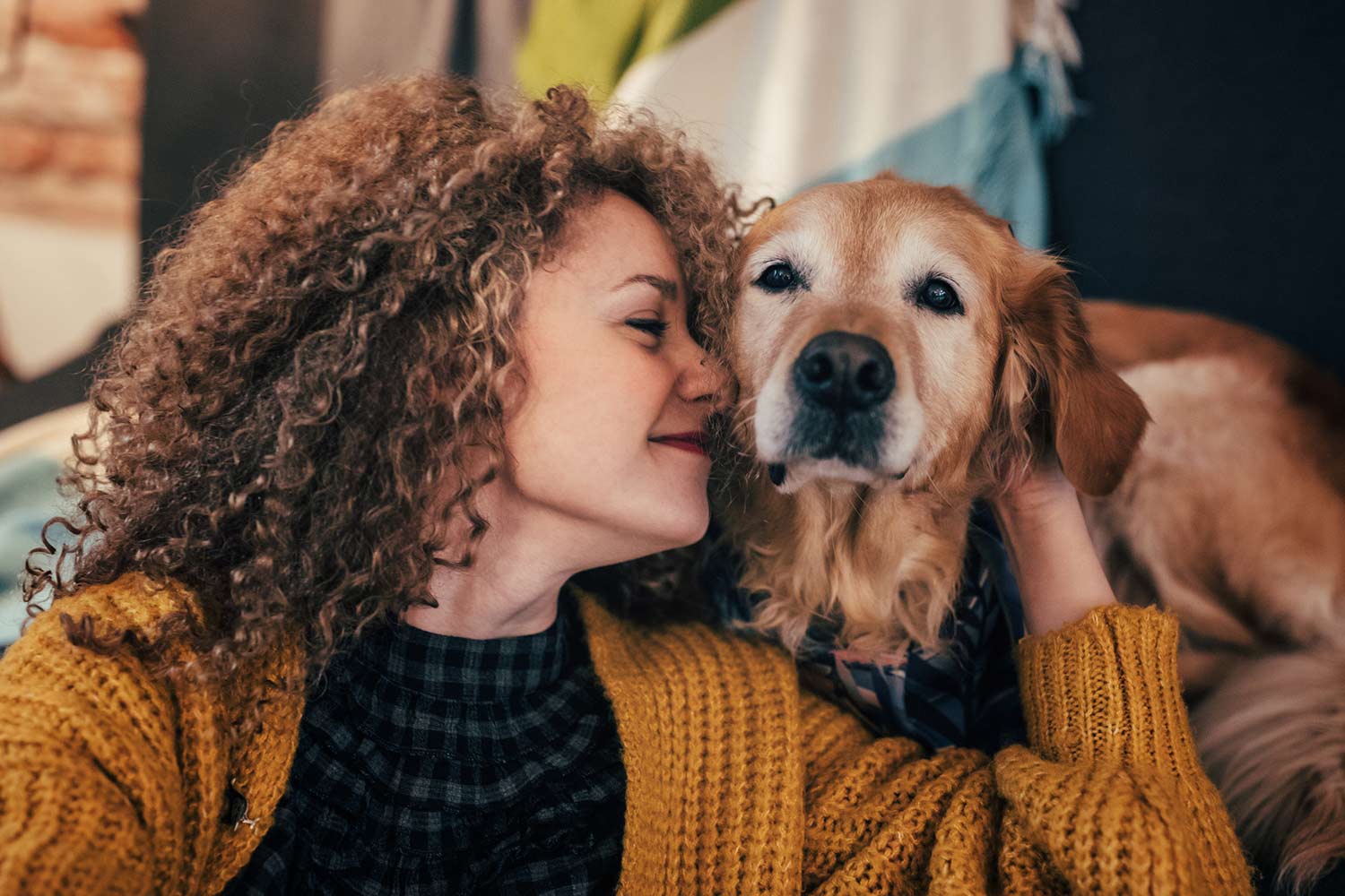 Woman playing with her dog at home.