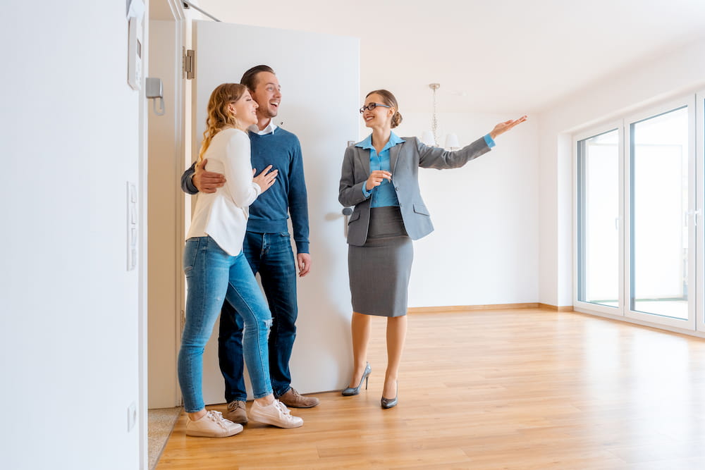 People happily viewing a property with an agent.
