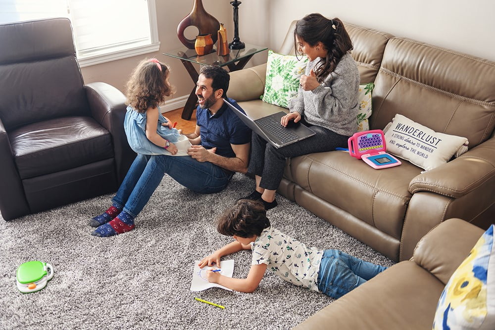 A family is sitting together in a cozy living room.