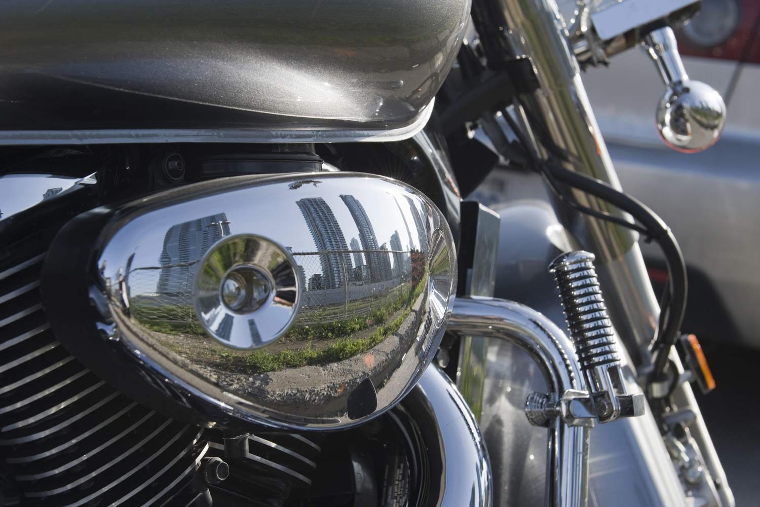 High modern building reflection in a motorbike.
