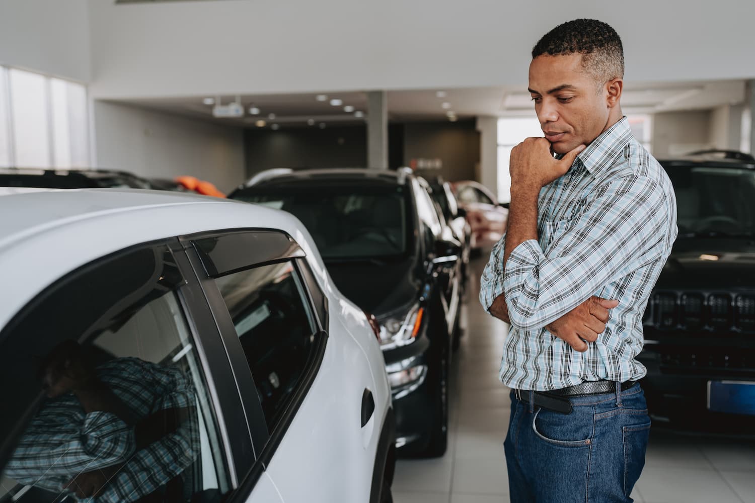 Person evaluating a car prior to buying.