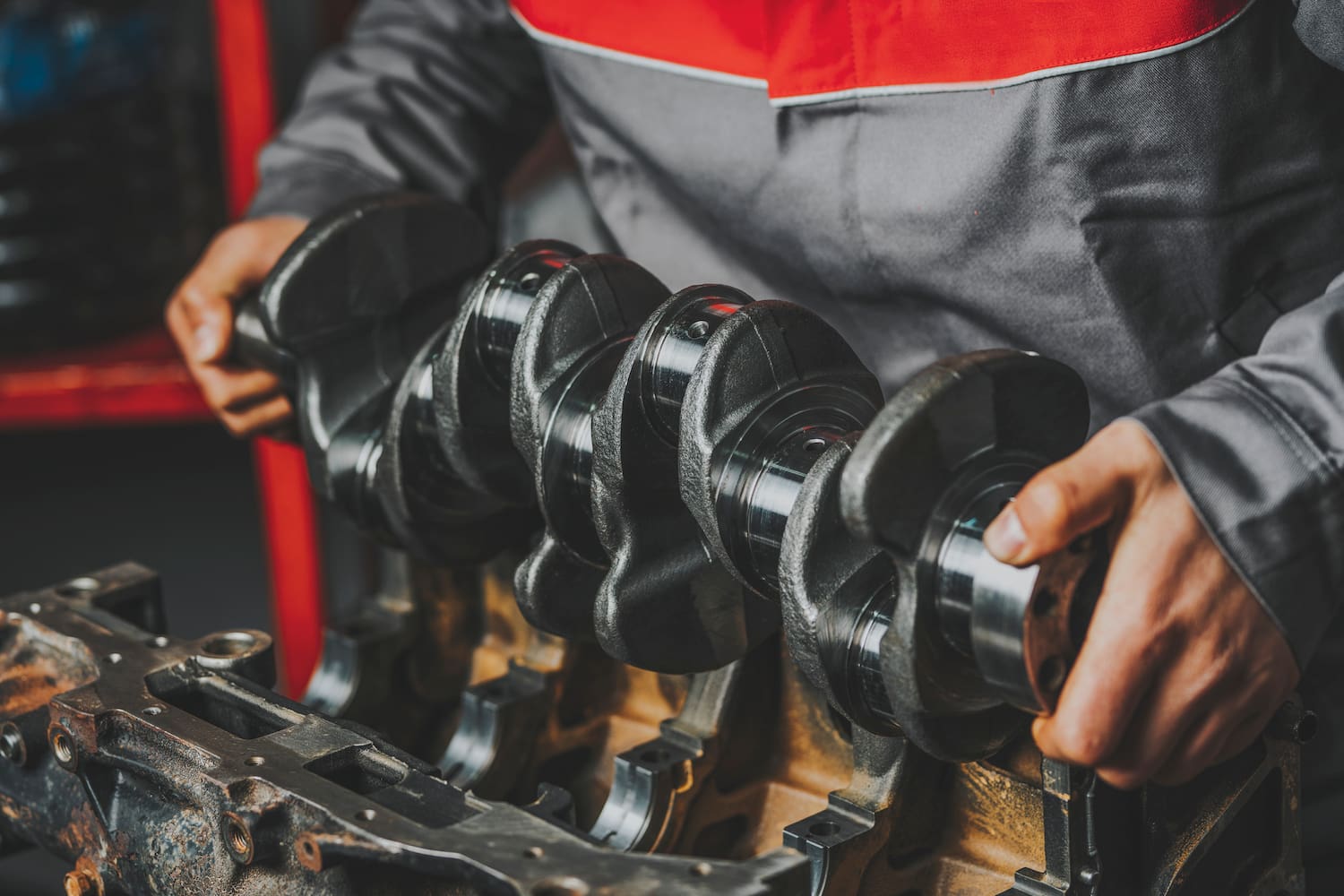 Close up of a car technician hands holding some car's parts