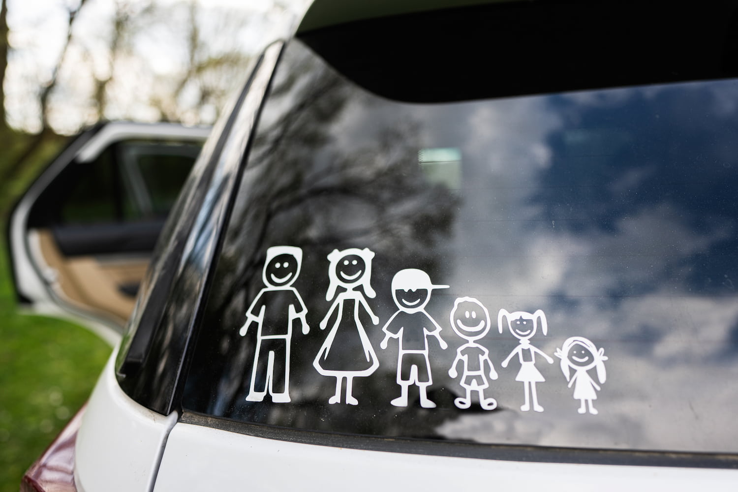 Happy family on board. Sticker on the back of car.