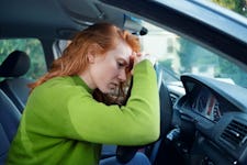 Stressed and tired woman at the wheel in her car