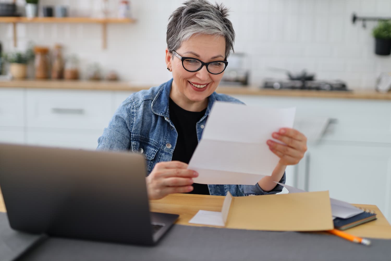 Woman smiling while reading document.