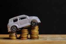 Miniature car on coin stack
