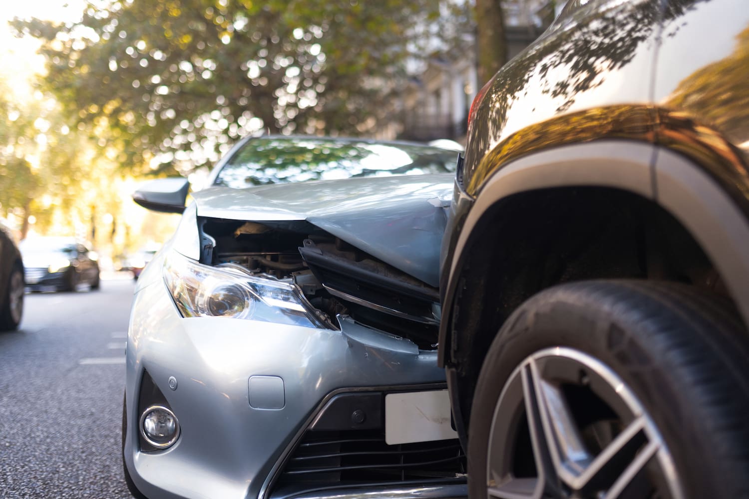 Close-up of two cars damaged in road traffic accident.