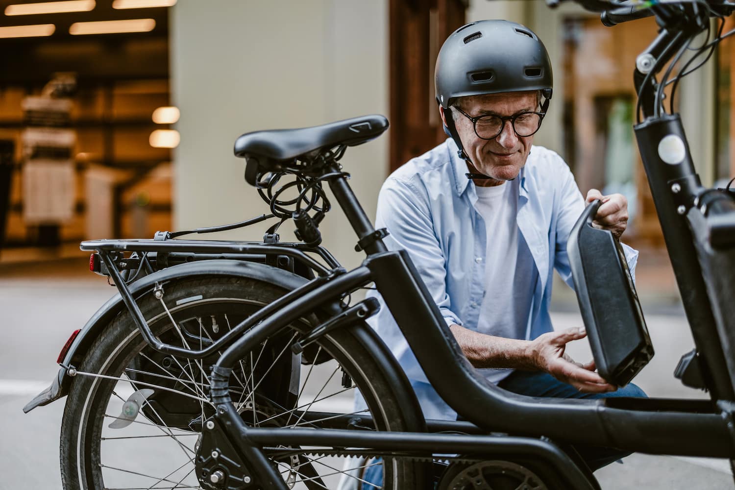 A person changing battery on electric bicycle.