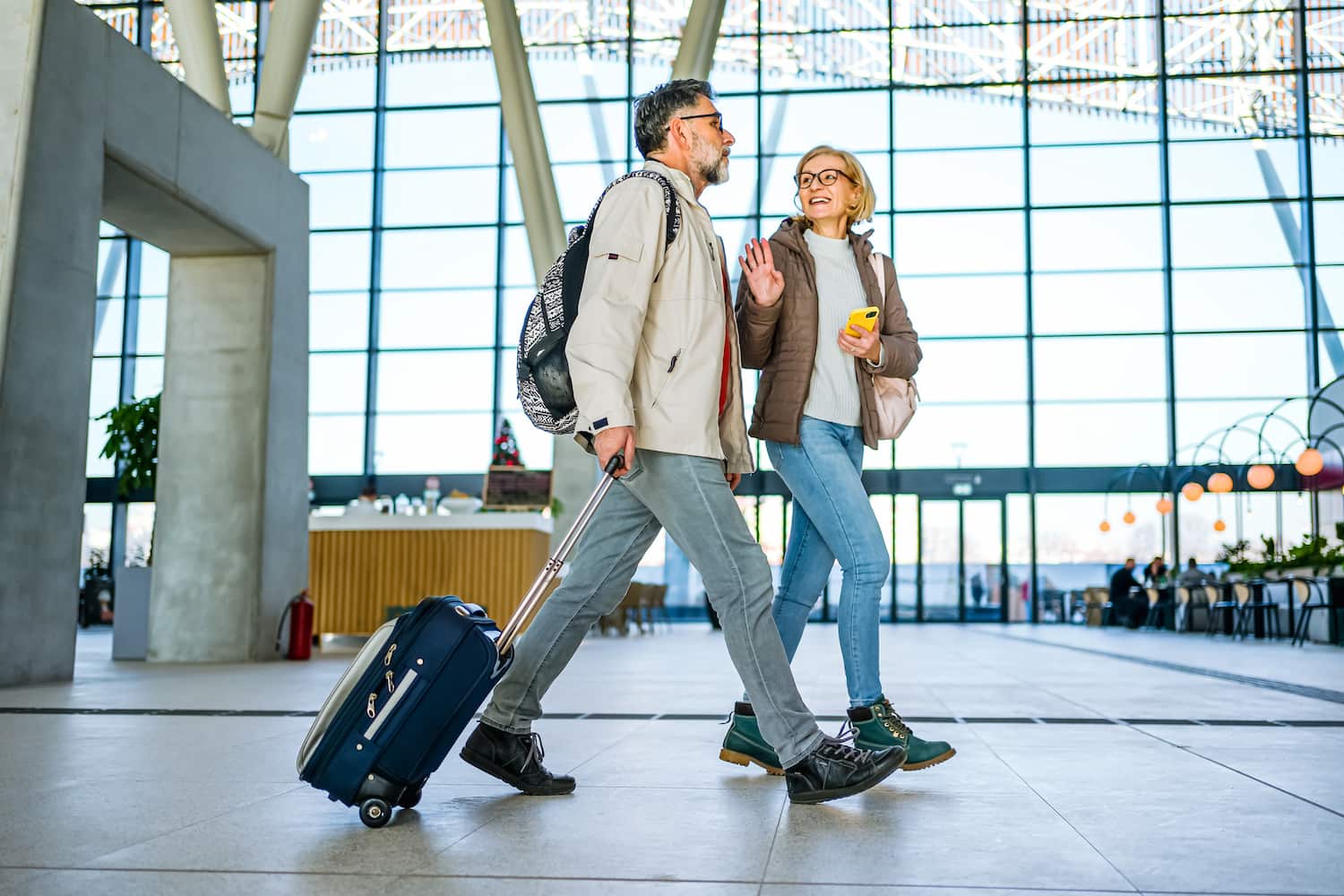 A mature couple waiting at a train station