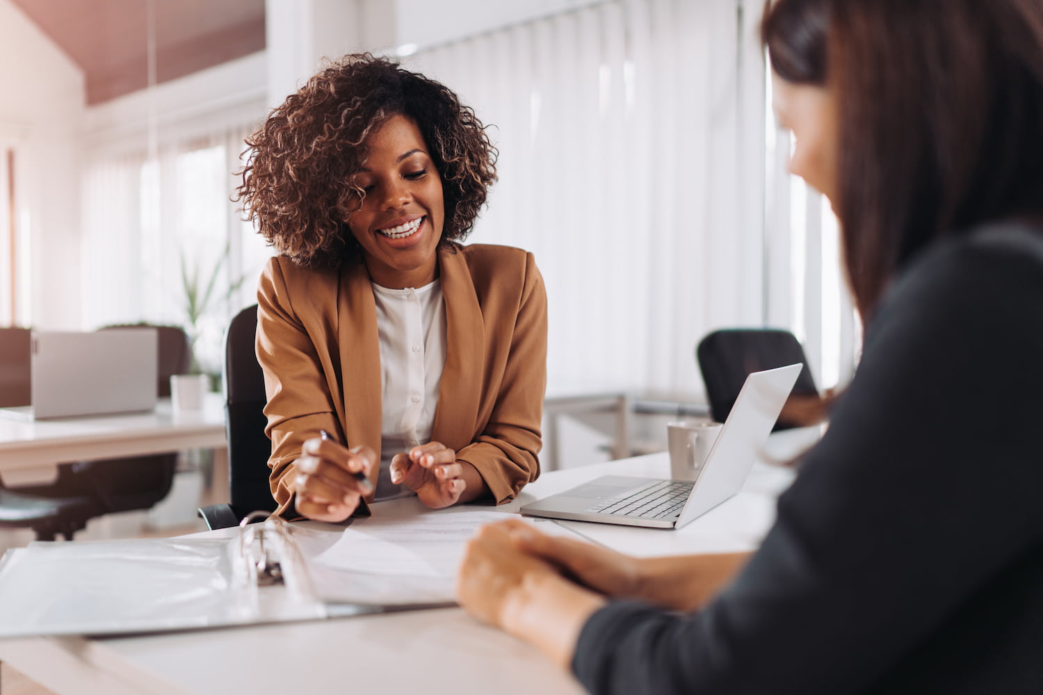 Female client consulting with an insurance agent in the office.