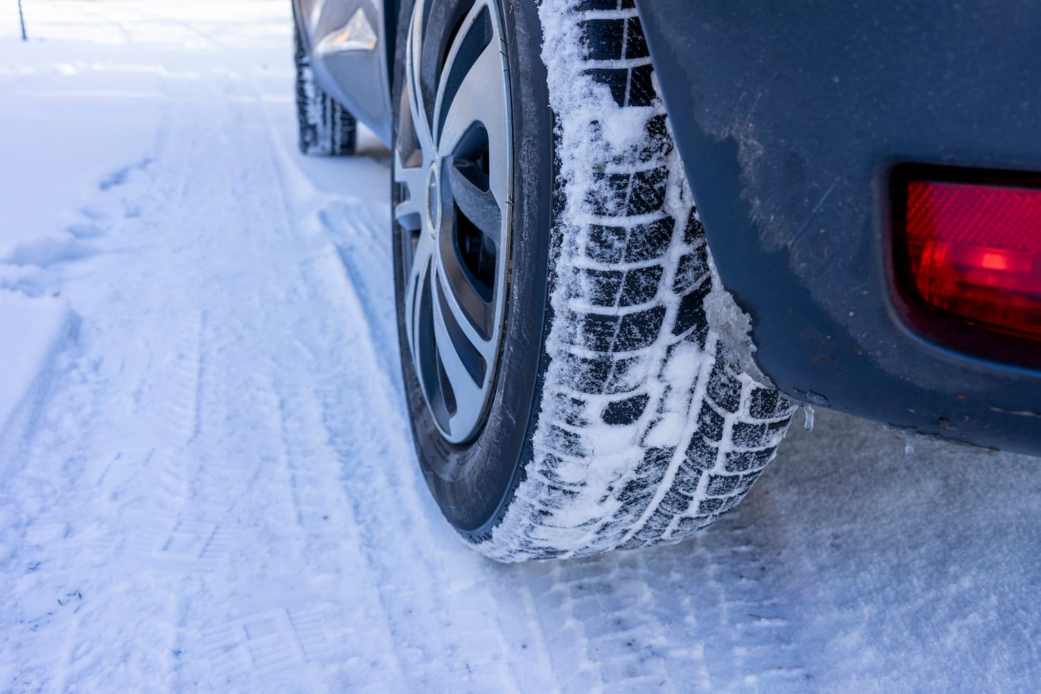 Car wheel in snow at winter season.