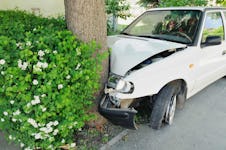 A side view of a head-on car crash into a tree
