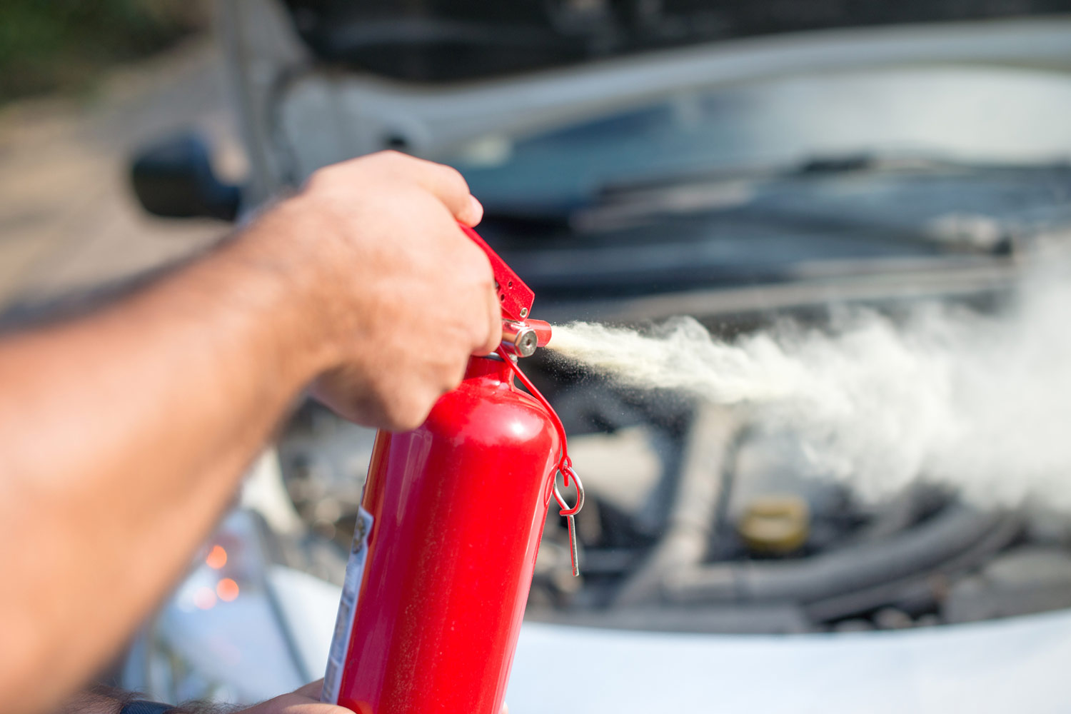 Person using car to extinguish a car fire